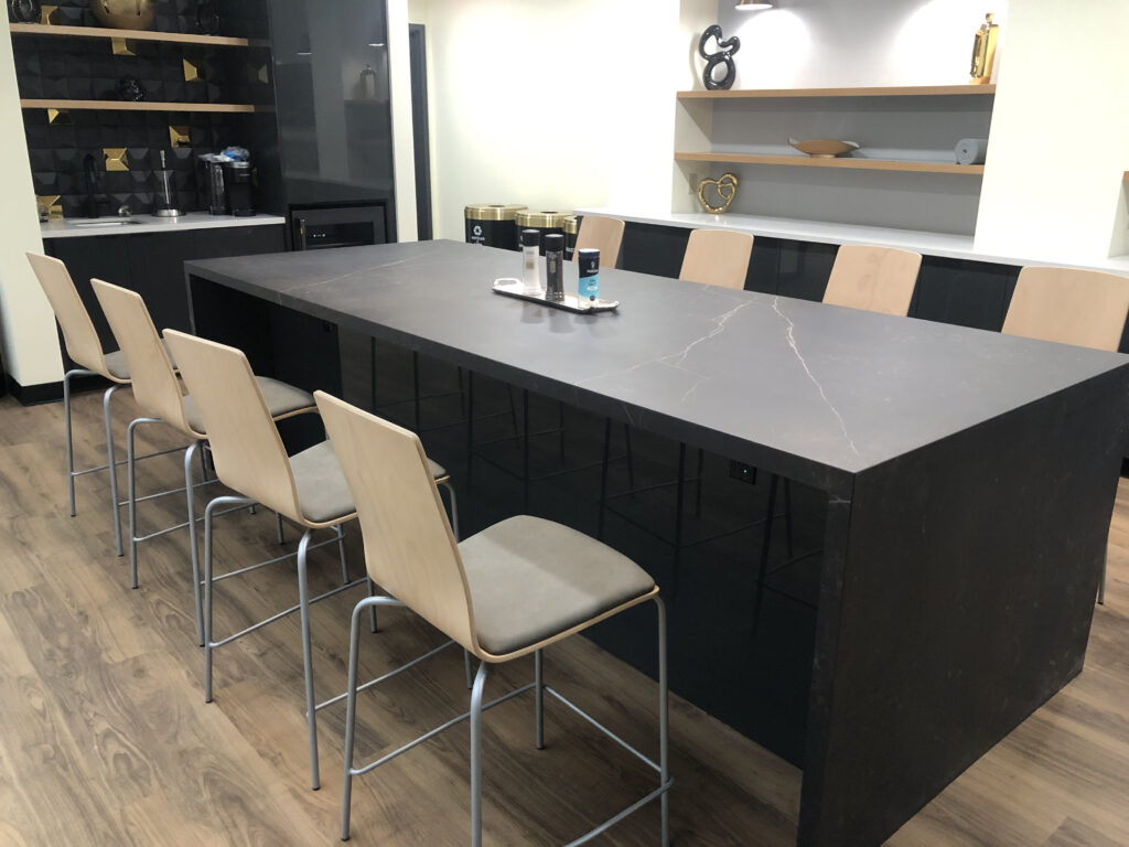 Office dining area with a black high-top table with seating for 8